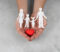 hands-holding-paper-people-heart-close-up